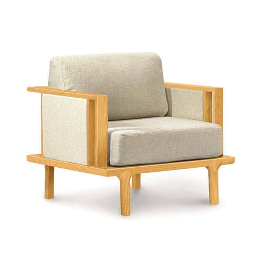 A modern single-seater Copeland Furniture Sierra Cherry Upholstered Chair with custom upholstery options and a wooden frame, isolated on a white background.