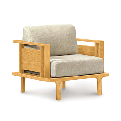 A single-seater Sierra Cherry upholstered chair from Copeland Furniture with custom upholstery in light gray cushions.