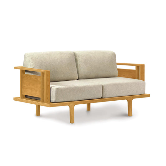 Sierra Upholstered Loveseat by Copeland Furniture featuring modern design, natural cherry wood frame, beige cushions, and open sides.
