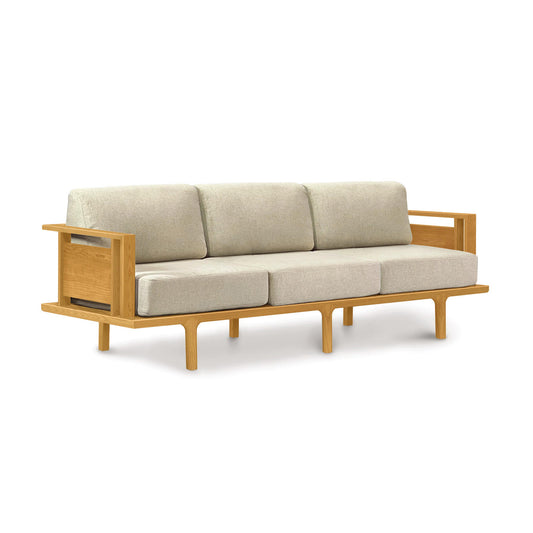 Modern handcrafted Copeland Furniture Sierra Sofa with a light wood frame, three beige cushions, and rectangular armrests.