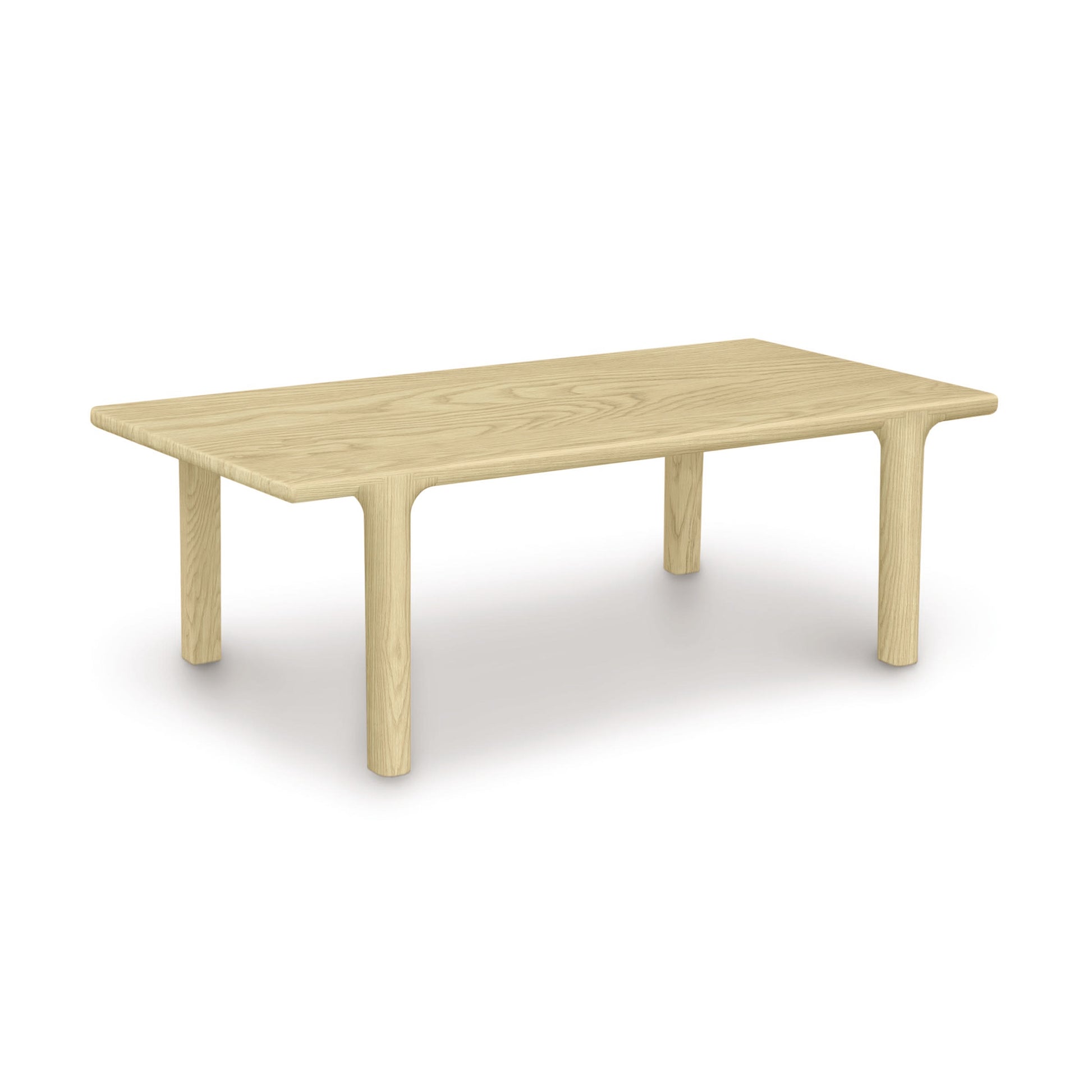 Sierra Rectangular Coffee Table by Copeland Furniture with rounded edges, thick cylindrical legs, and customizable wood finishes highlighted in a close-up view.