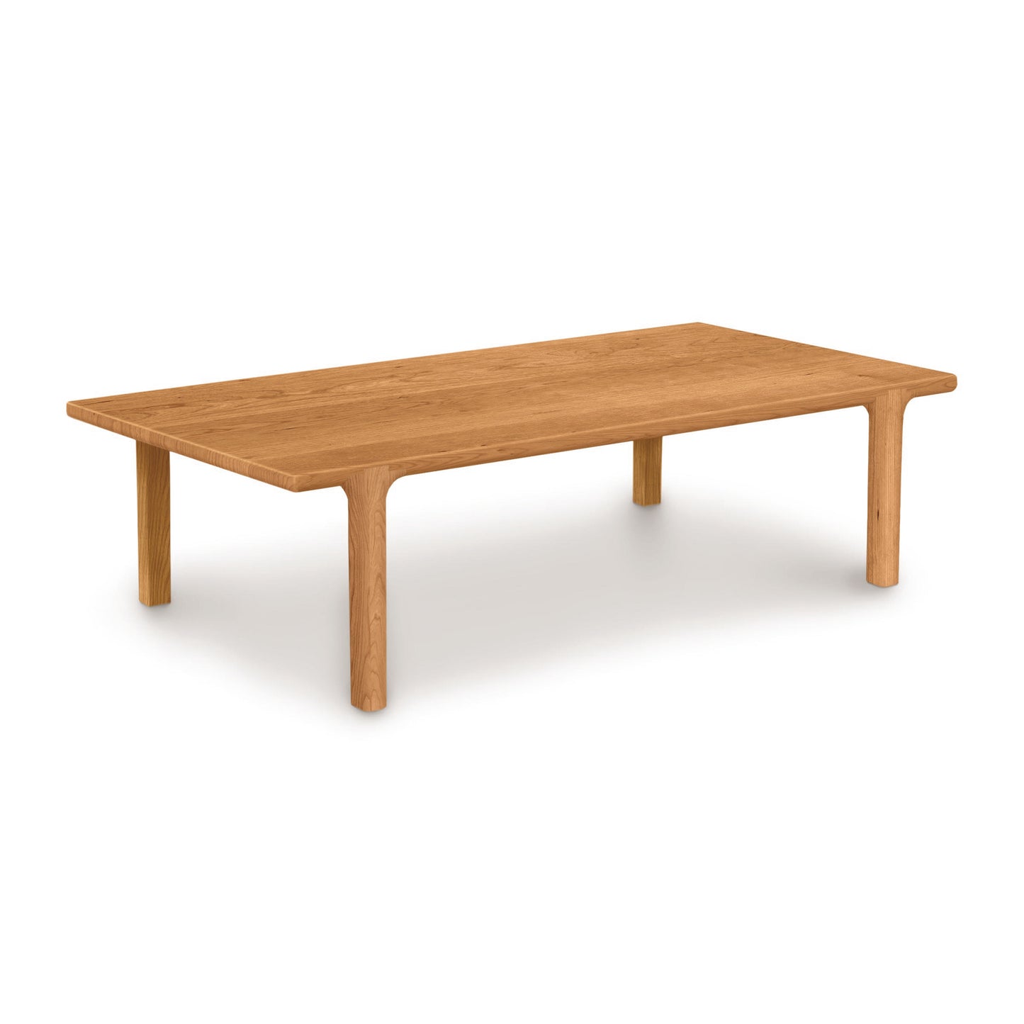 A simple Copeland Furniture Sierra Rectangular Coffee Table made of solid North American hardwood with four round legs on a white background.