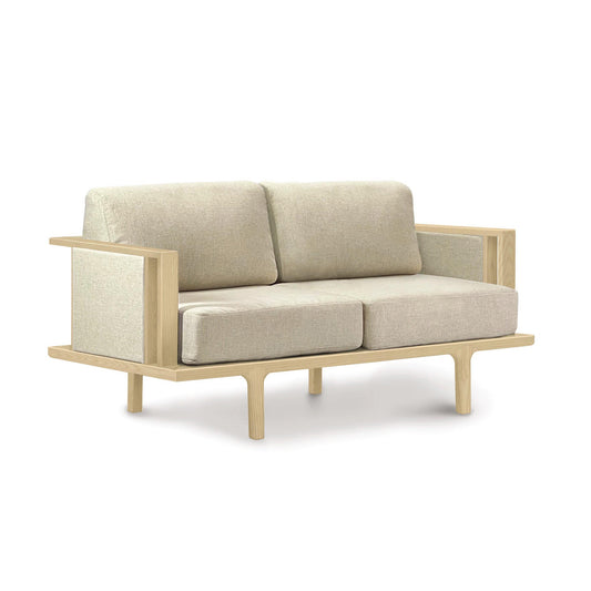 A modern two-seater Copeland Furniture Sierra Oak Upholstered Loveseat with Upholstered Panels and a wooden frame.