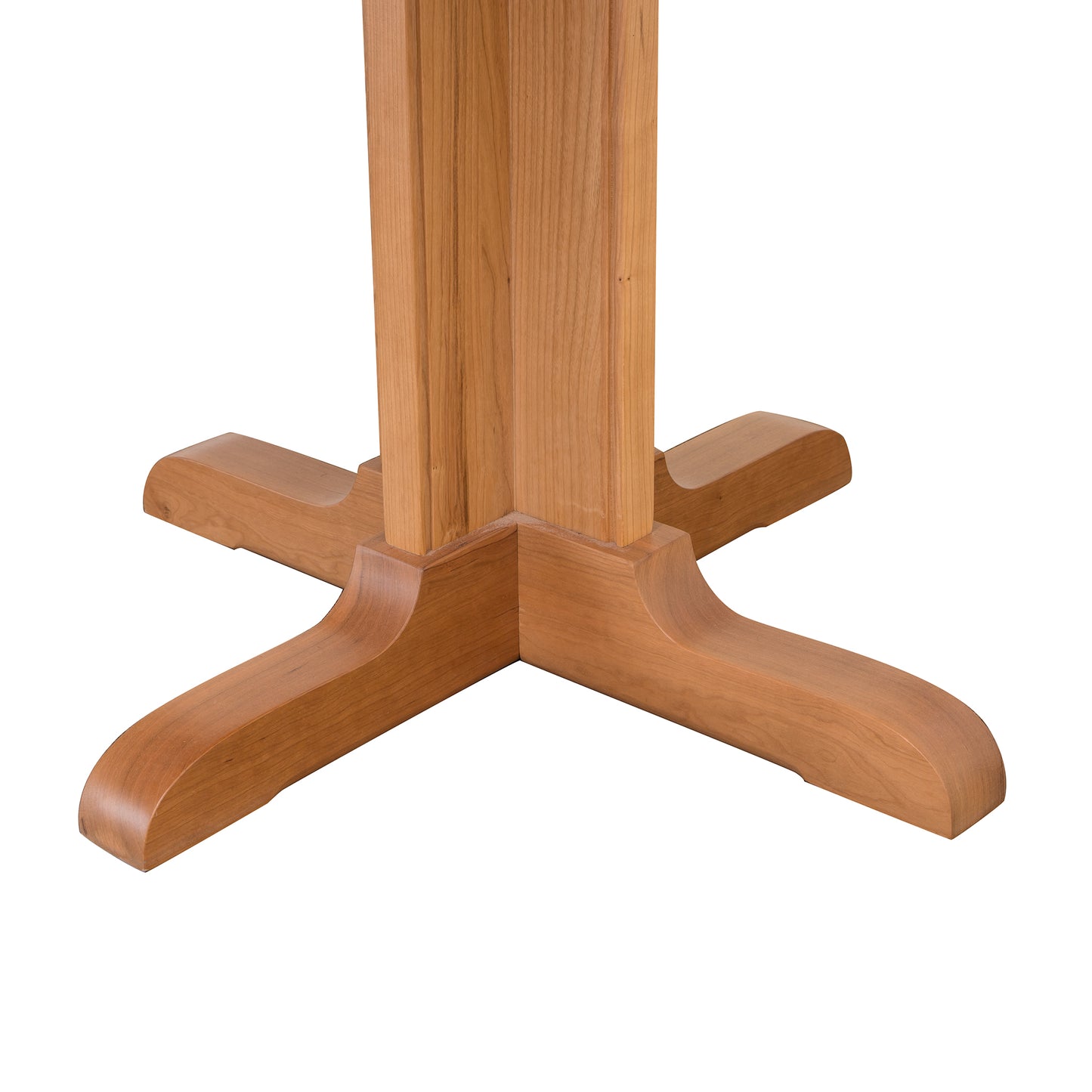 Lyndon Furniture Single-Leg Round Pedestal Table crafted in natural cherry with four curved legs, displayed from a low angle.