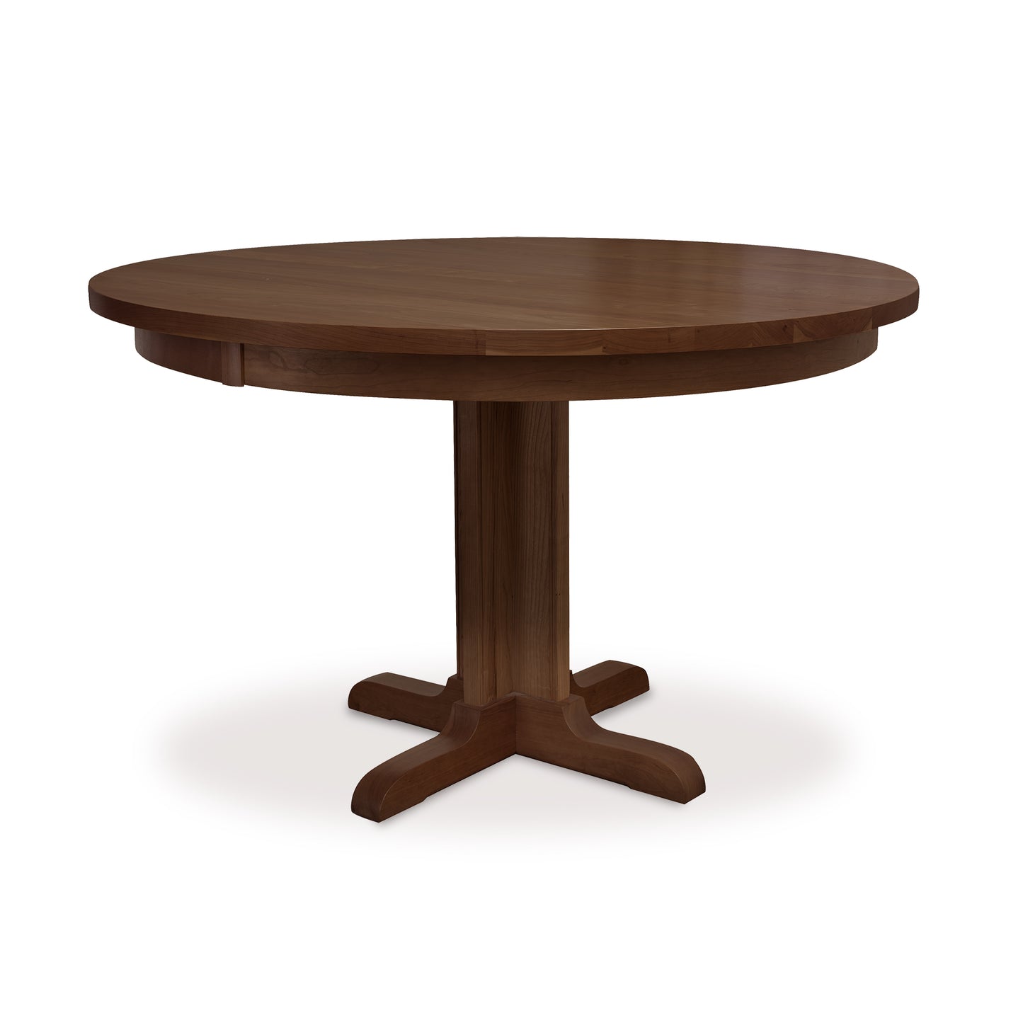 Lyndon Furniture Single-Leg Round Pedestal Table in natural cherry with solid top and four-footed base, highlighting its elegant craftsmanship.