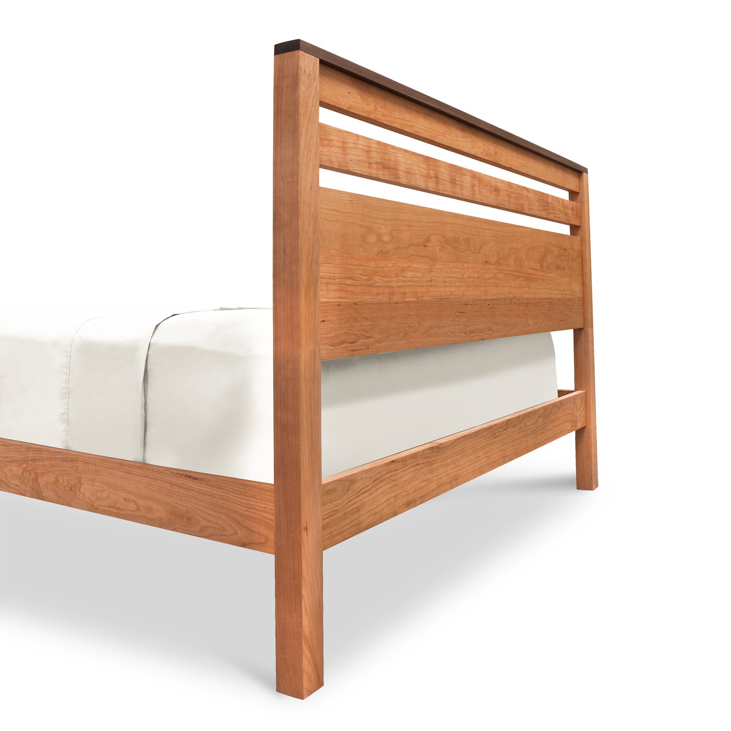 Skyline Queen Panel Bed by Vermont Furniture Designs in natural cherry, slatted headboard, white bedding, shown from rear side angle.