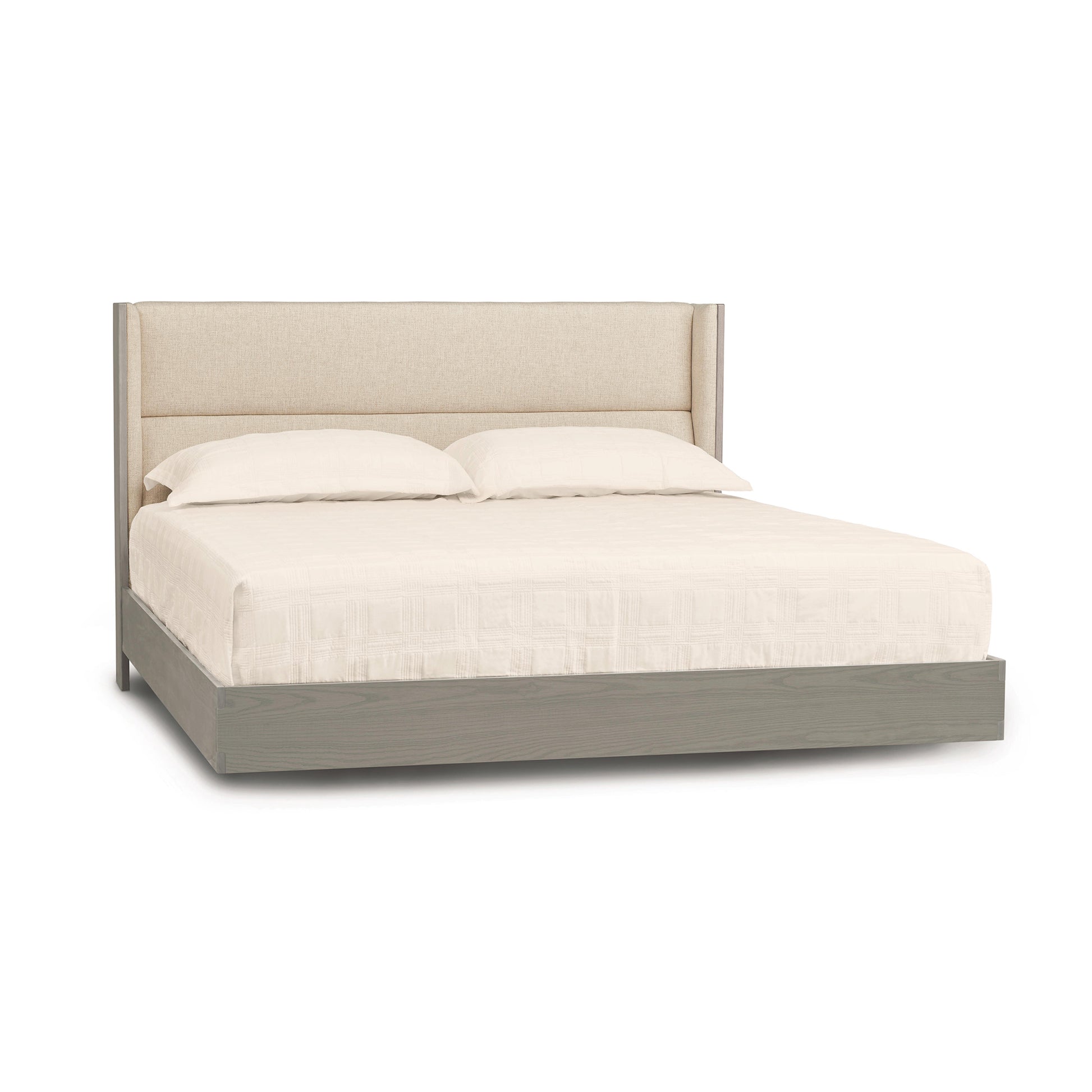 Sloane Floating Bed by Copeland Furniture with beige upholstered headboard and light gray wood platform, shown with white bedding.