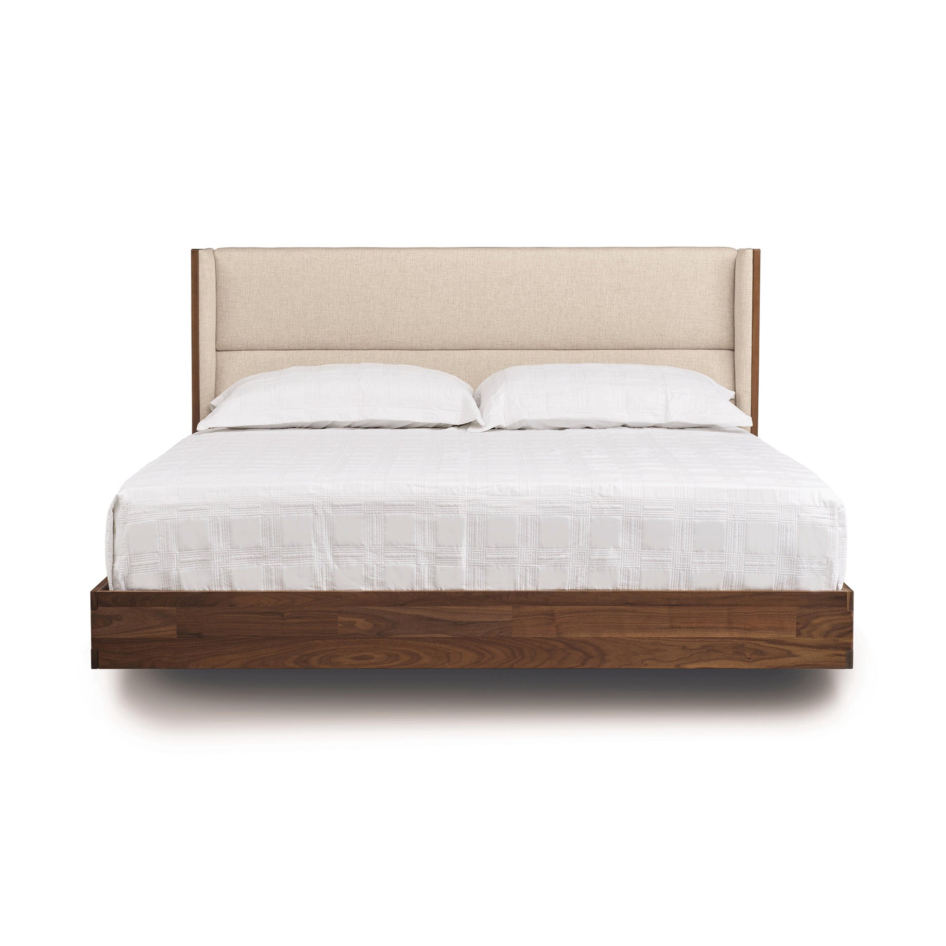 A modern Copeland Furniture Sloane Floating Bed with a beige headboard and white bedding on an isolated white background.