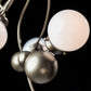 A close up of a Hubbardton Forge Sprig Pendant light fixture with white balls.