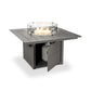 POLYWOOD Square 42" Fire Pit Table with a protective glass wind guard and an integrated compartment for a propane tank, set against a plain white background.