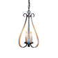 A Sweeping Taper 3-Arm Chandelier by Hubbardton Forge, with three candles hanging from it, showcasing a timeless style in a traditional design.