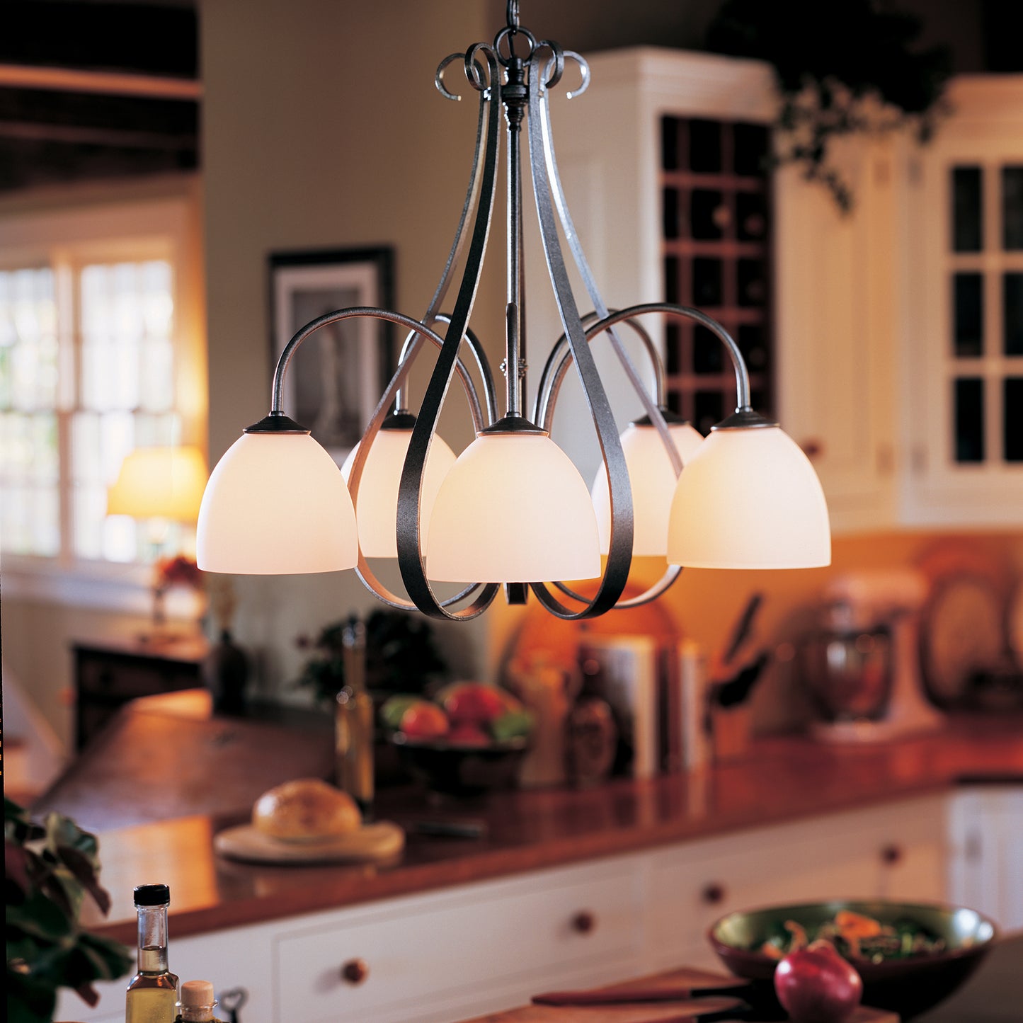 Hubbardton Forge Sweeping Taper 5-Arm Chandelier with frosted glass shades.