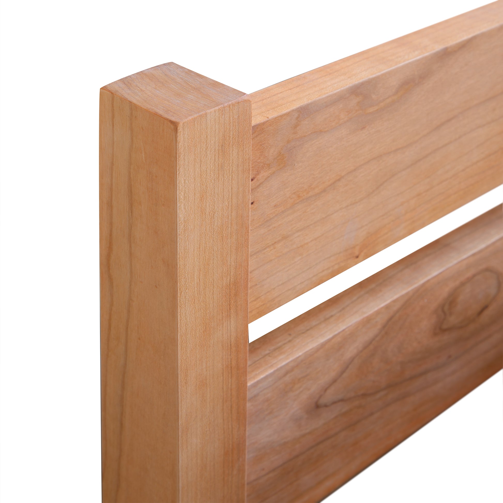 Vergennes Platform Bed's eco-friendly hardwood headboard showcasing a simple design and prominent wood grain.