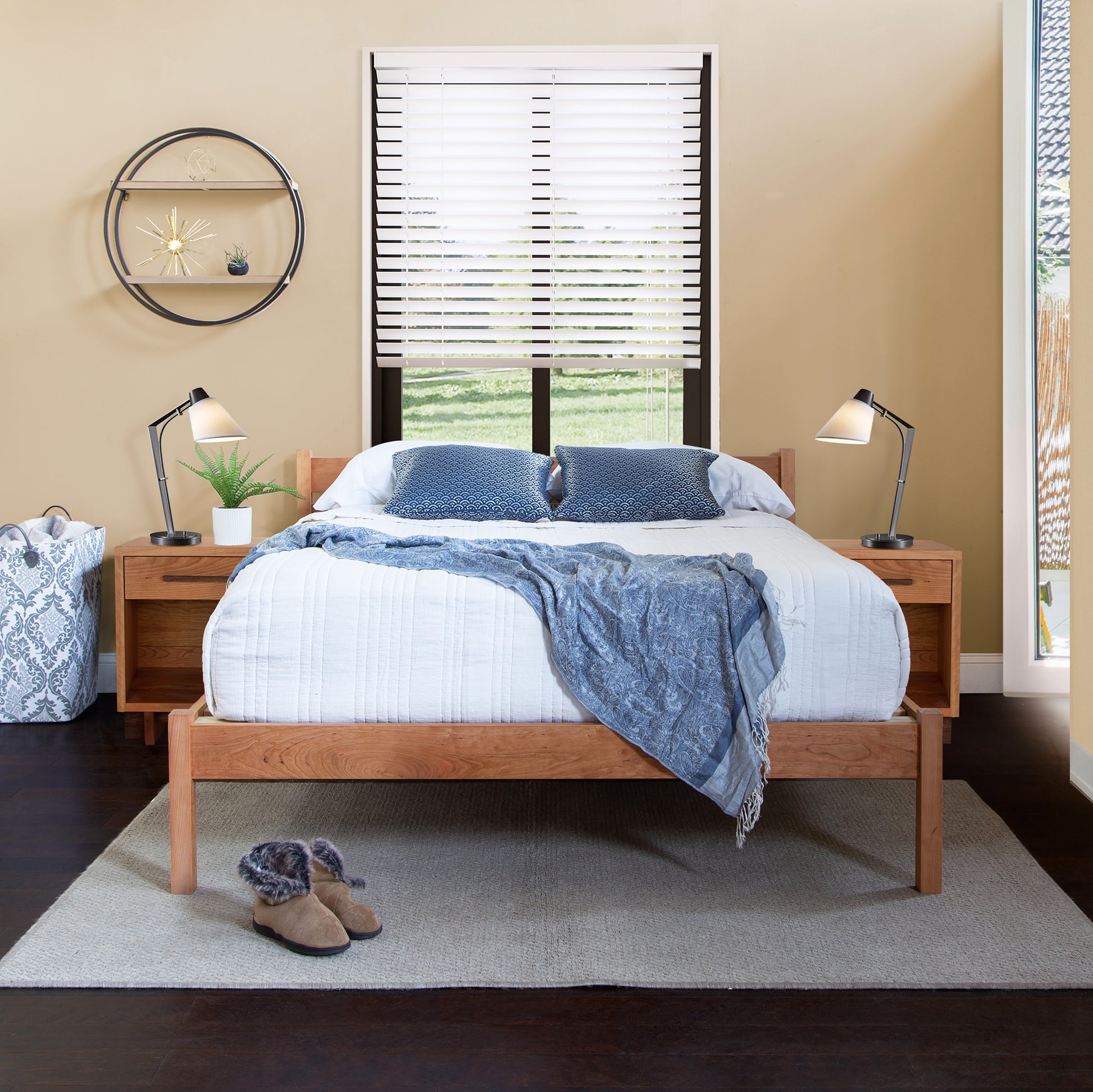 Vermont Furniture Designs Vergennes Bed with white and blue bedding, accompanied by two nightstands.