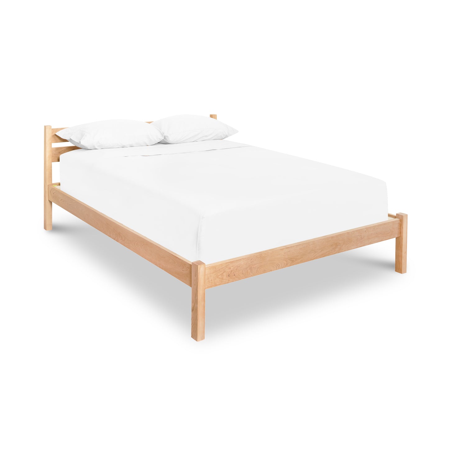 Vergennes Platform Bed crafted from eco-friendly hardwood with a white mattress and pillows by Vermont Furniture Designs.