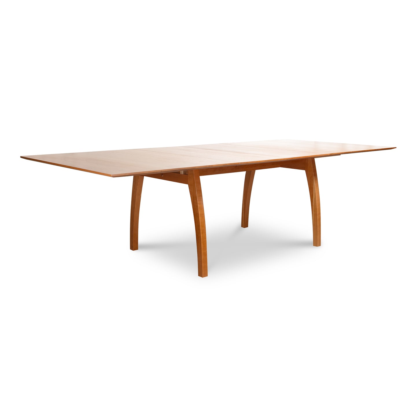 Lyndon Furniture Vermont Modern Extension Trestle Table in 48"x72" size with curved legs and extension leaves, showcasing sleek modern craftsmanship.