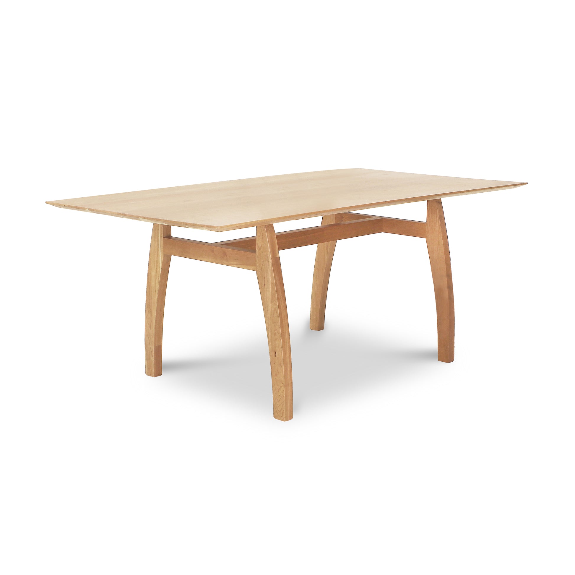 Vermont Modern Solid Top Trestle Table by Lyndon Furniture with light wood finish and distinctive curved legs, highlighting craftsmanship and modern design.