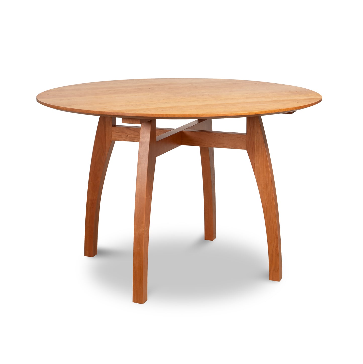 Vermont Modern Round Solid Top Pedestal Table by Lyndon Furniture with four curved legs and natural wood grain.
