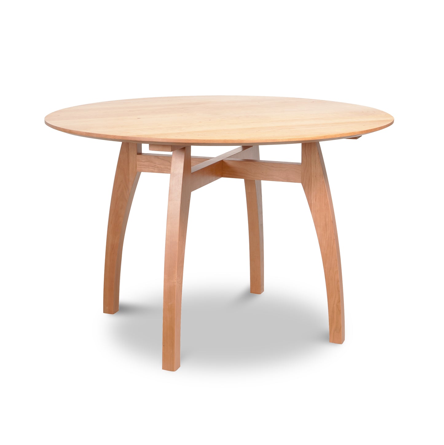 Vermont Modern Round Solid Top Pedestal Table by Lyndon Furniture with four curved legs and a light natural wood finish.