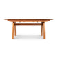 A high-end Vermont Modern Butterfly Extension Table by Lyndon Furniture with two legs and a wooden top.