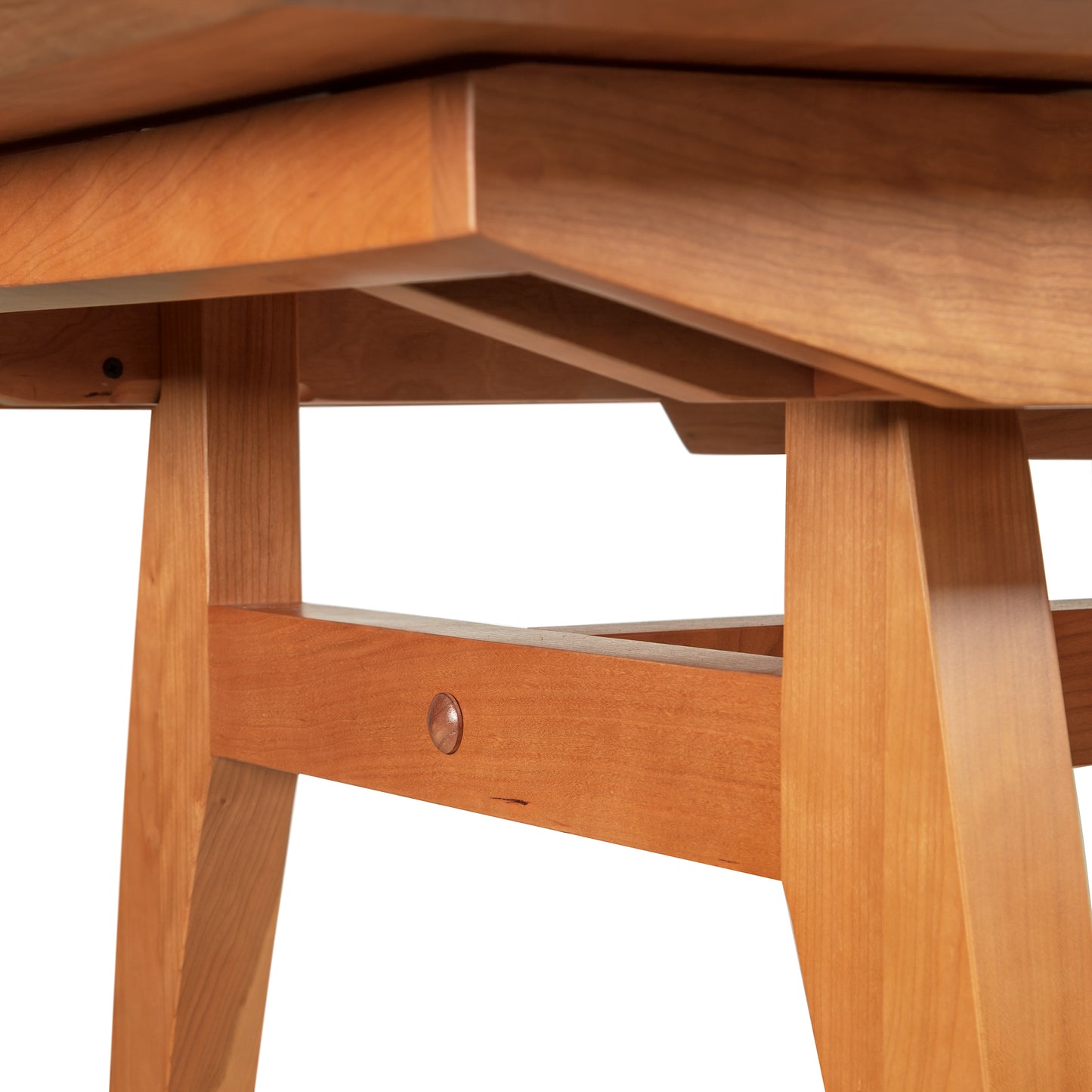 Detail view of artisan joinery on the solid wood legs and underframe of the Vermont Modern Butterfly Extension Table by Lyndon Furniture.