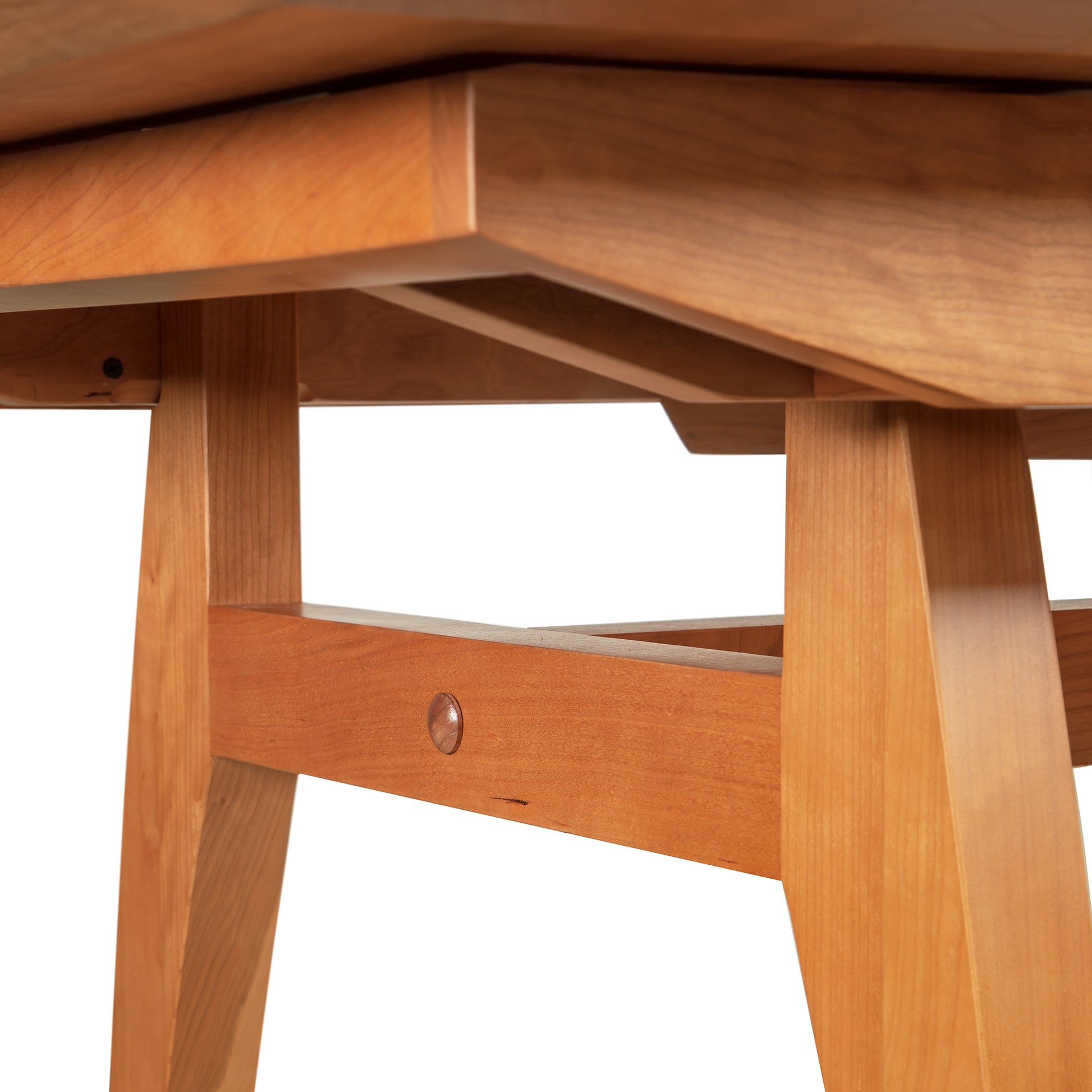 Detail view of artisan joinery on the solid wood legs and underframe of the Vermont Modern Butterfly Extension Table by Lyndon Furniture.