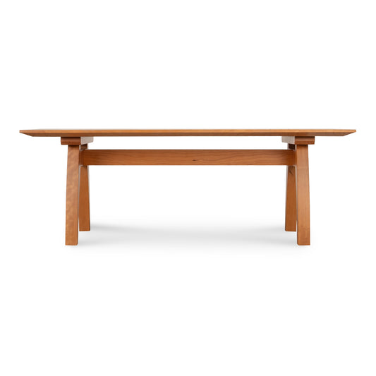 Contemporary Vermont Modern Trestle Coffee Table by Lyndon Furniture with a sleek wooden rectangular top and angled legs.