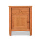 A Vermont Shaker 1-Drawer Nightstand with Door from Maple Corner Woodworks, featuring a natural cherry wood finish, one drawer, and a cabinet door, set against a plain white background.