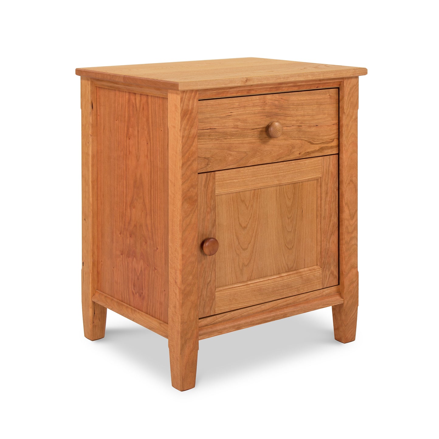 A Maple Corner Woodworks Vermont Shaker 1-Drawer Nightstand with Door, crafted from natural cherry wood, isolated on a white background.