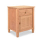 A Maple Corner Woodworks Vermont Shaker 1-Drawer Nightstand with Door, featuring a single drawer and a cabinet door, set against a white background. The table is made from natural cherry wood with visible grain patterns.