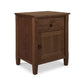 A Maple Corner Woodworks Vermont Shaker 1-Drawer Nightstand with Door, featuring a single drawer and a cabinet door, set against a white background. The piece is made from natural cherry wood with visible grain patterns.