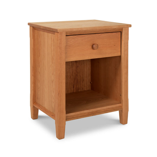 A Maple Corner Woodworks Vermont Shaker 1-Drawer Enclosed Shelf Nightstand, crafted from natural hardwoods with a single drawer and an open shelf, isolated on a white background.