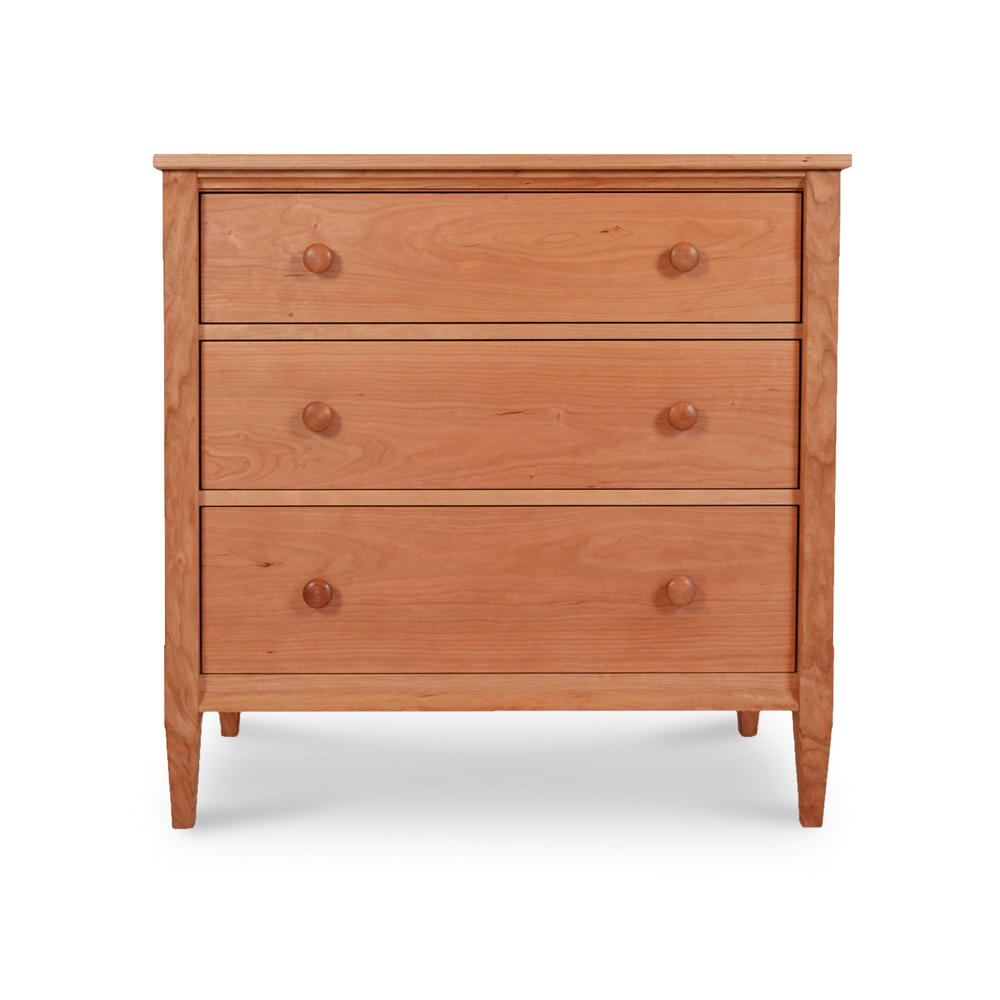A Maple Corner Woodworks Vermont Shaker 3-Drawer Chest with three parallel drawers, each featuring a rounded knob. The furniture stands on four legs and is set against a white background.