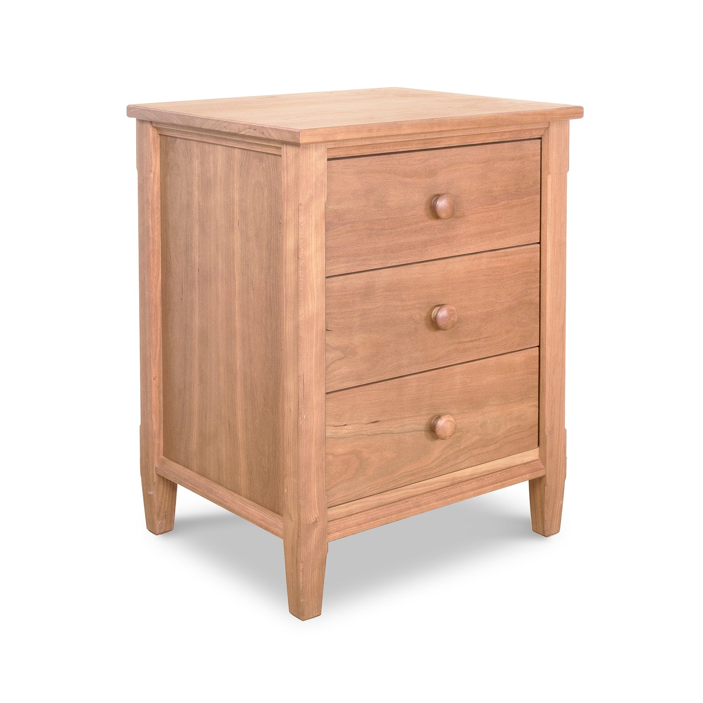 A wooden three-drawer Maple Corner Woodworks Vermont Shaker Nightstand with round knobs on a white background. The nightstand features a smooth finish and stands on four sturdy legs.