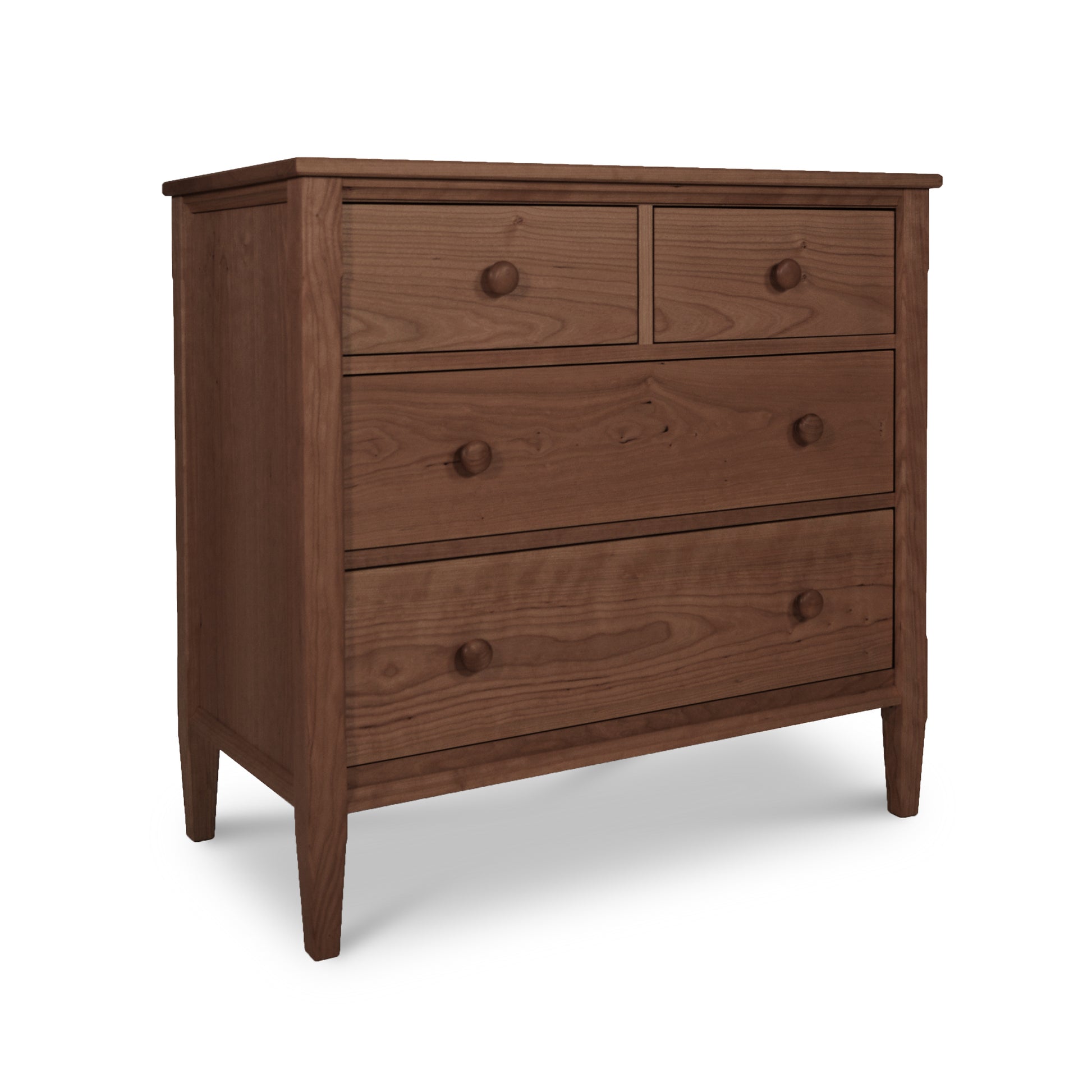 A Vermont Shaker 4-Drawer Chest by Maple Corner Woodworks: two small drawers at the top and two larger drawers below, set on angled legs. The dresser has round knobs and is crafted from solid cherry wood.