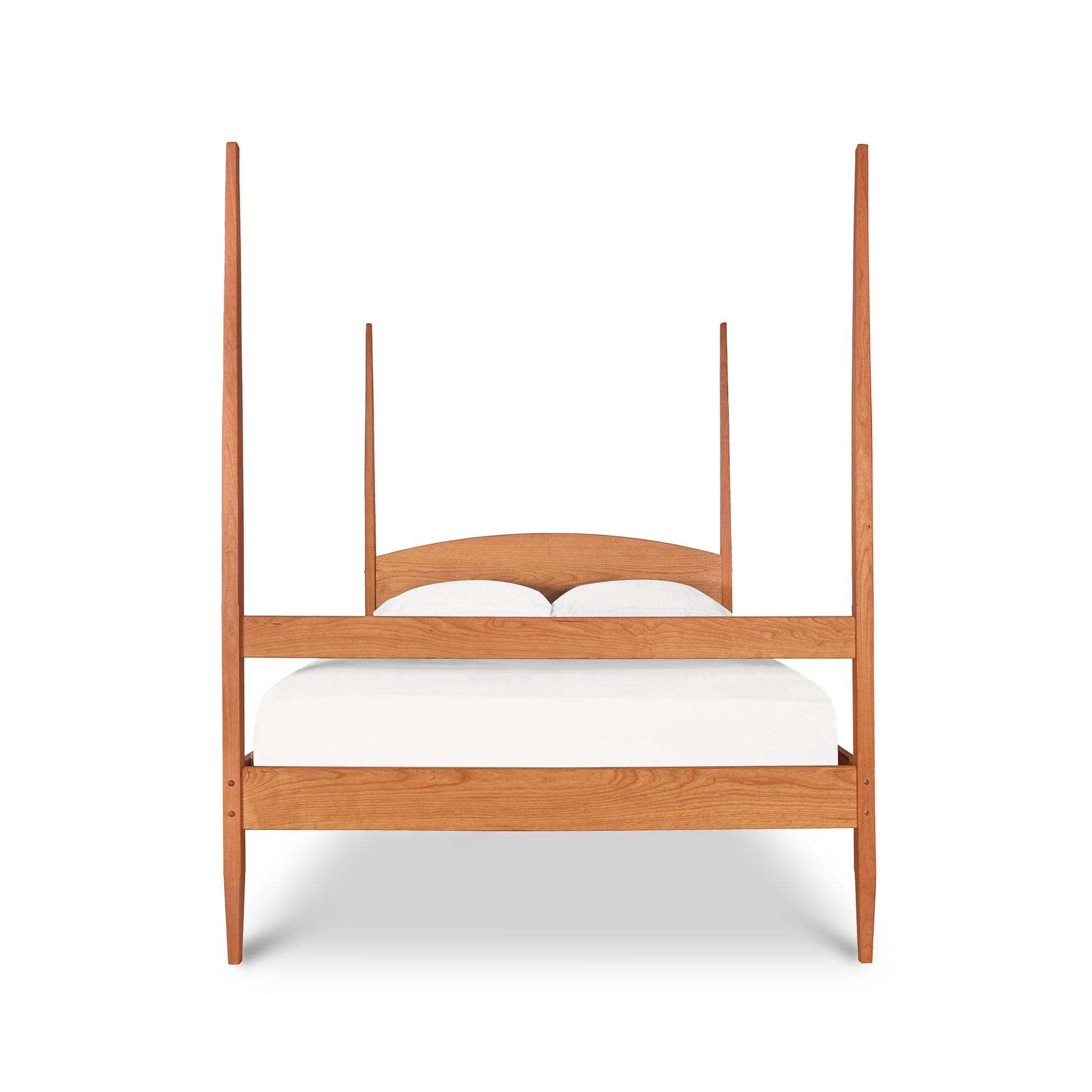 Vermont Shaker Four Poster Bed by Maple Corner Woodworks featuring a curved headboard and solid wood construction with a white mattress.