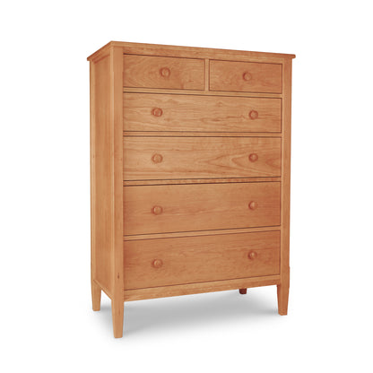 A wooden six-drawer Vermont Shaker Chest with round knobs and a smooth finish, isolated on a white background.