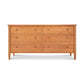 A Vermont Shaker 6-Drawer Dresser by Maple Corner Woodworks with a light brown finish and round knobs, set against a plain white background.
