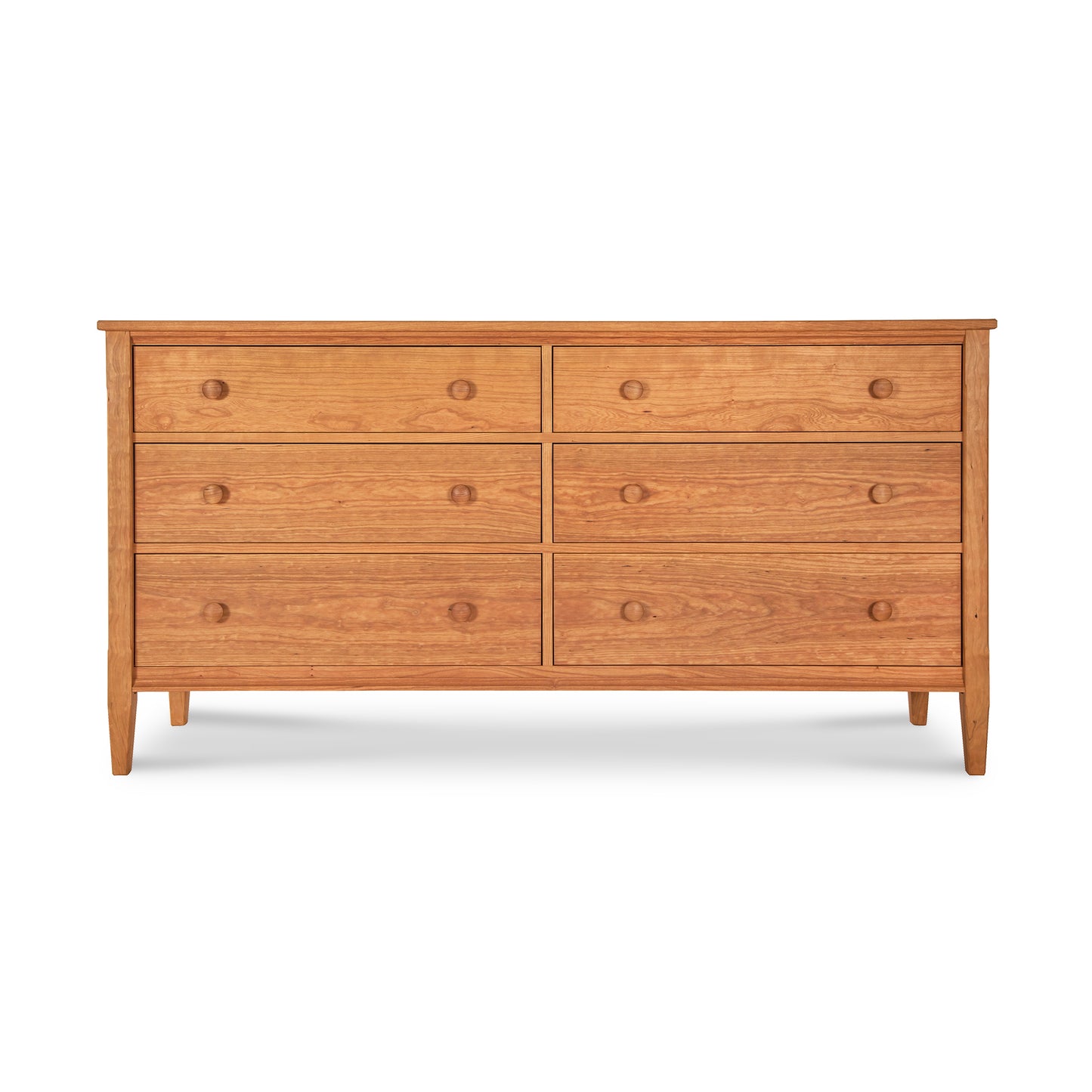 A Maple Corner Woodworks Vermont Shaker 6-Drawer Dresser with six drawers, arranged in two columns of three, featuring round knobs and slightly tapered legs, against a plain white background.