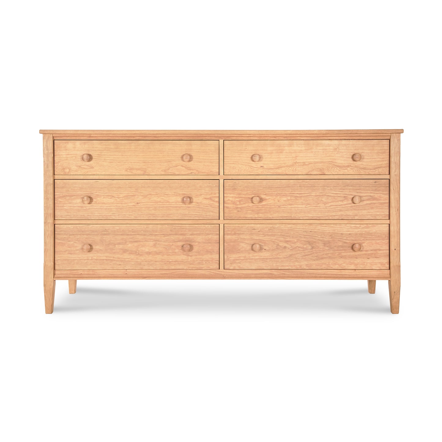 A Vermont Shaker 6-Drawer Dresser from Maple Corner Woodworks, featuring a simple, streamlined design and round wooden knobs, set against a plain white background.