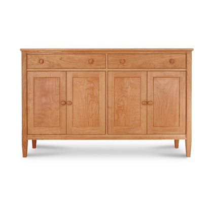 A Maple Corner Woodworks Vermont Shaker Large 60" Sideboard featuring three drawers centered between two cabinet doors, all crafted from natural cherry. The cabinet stands on four slender legs, isolated on a white background.