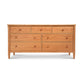 A handcrafted Vermont Shaker 7-Drawer Dresser from Maple Corner Woodworks, featuring a natural finish and round knobs, isolated against a white background.
