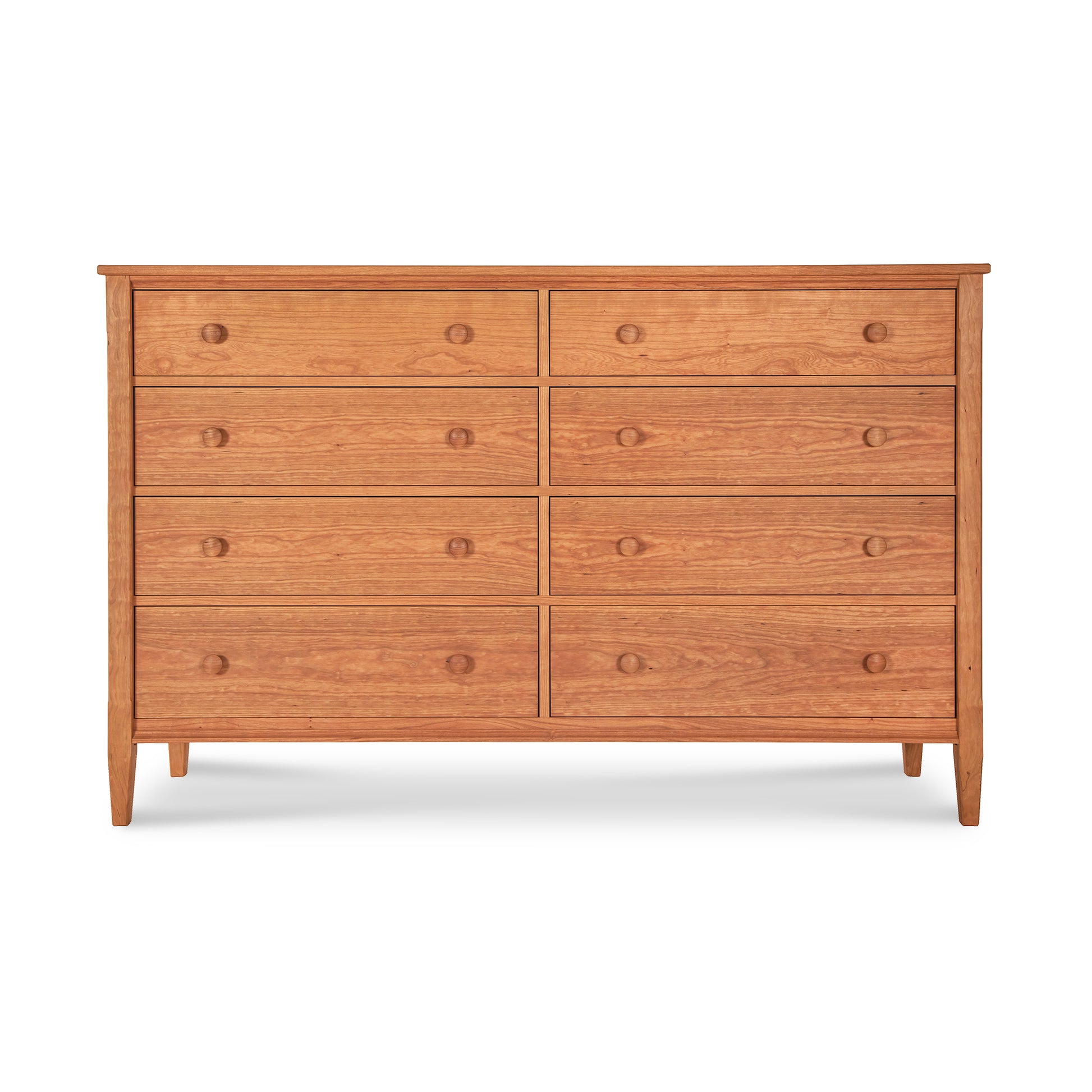 A Maple Corner Woodworks Vermont Shaker 8-Drawer Dresser, crafted from solid hardwoods, featuring a simple, traditional design with round handles, set against a plain white background.