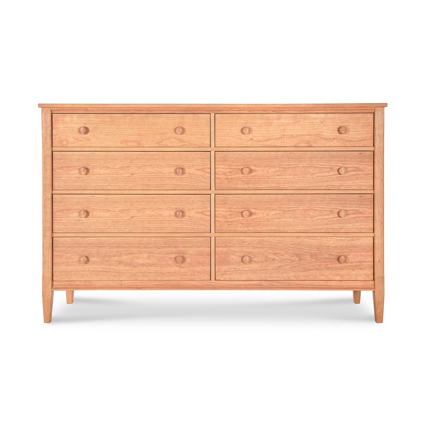 A Vermont Shaker 8-Drawer Dresser from Maple Corner Woodworks, featuring a light brown finish and round knobs. It has two smaller drawers on top of six larger ones, all against a plain white background.