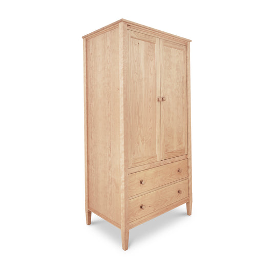 Vermont Shaker Armoire by Maple Corner Woodworks, solid wood with two doors and two drawers with round knobs, standing on four legs.
