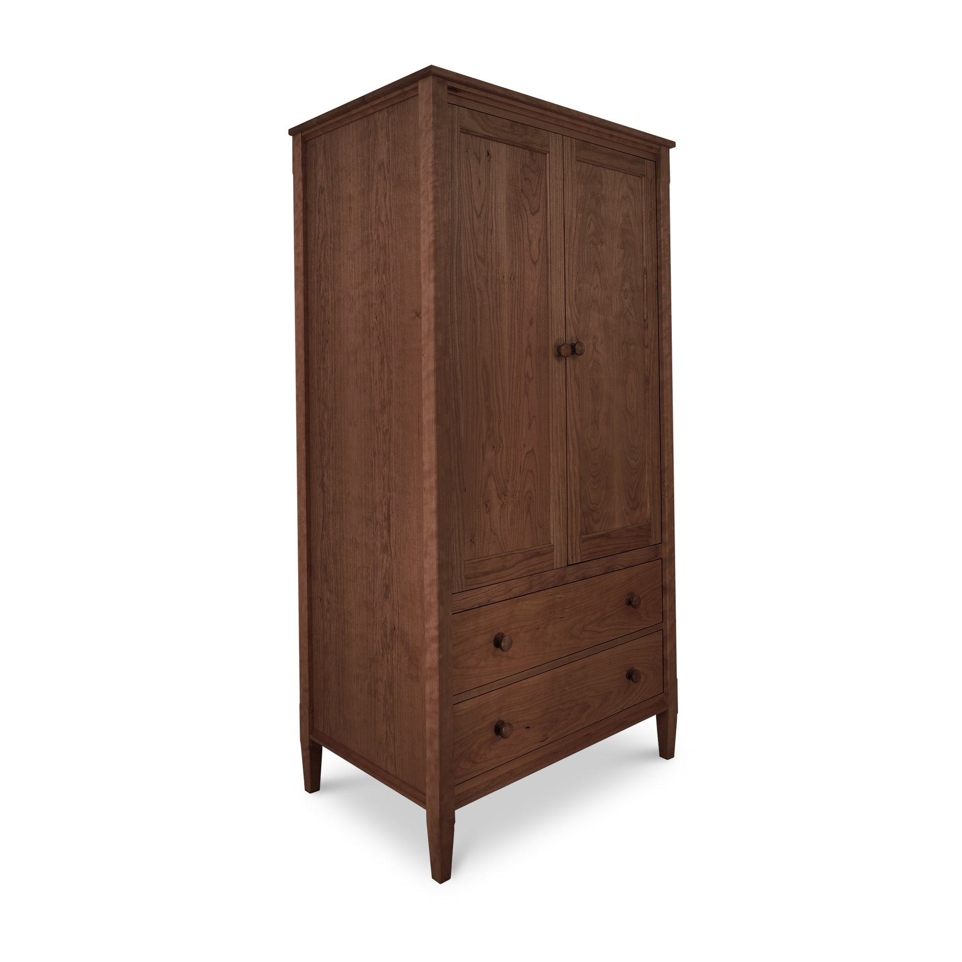 A Maple Corner Woodworks Vermont Shaker Armoire, a wooden wardrobe of heirloom quality with two doors above and a drawer below, standing against an isolated white background.