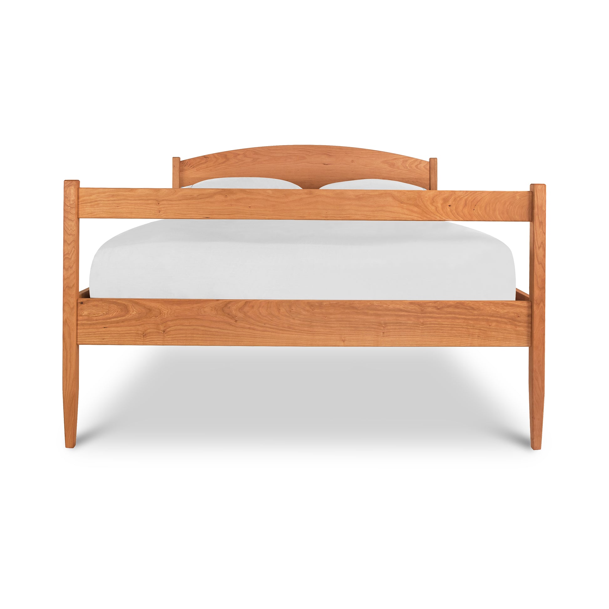 Vermont Shaker Bed by Maple Corner Woodworks with a light wood finish, showcasing its minimalist wooden frame and integrated underbed storage.