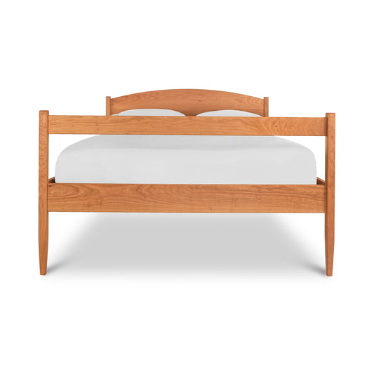 Vermont Shaker Bed by Maple Corner Woodworks with a light wood finish, showcasing its minimalist wooden frame and integrated underbed storage.