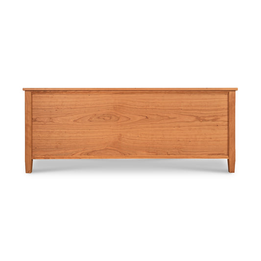 Vermont Shaker Blanket Chest by Maple Corner Woodworks with smooth finish, flat top, and panel detailing, crafted from sustainably harvested woods on four short legs.