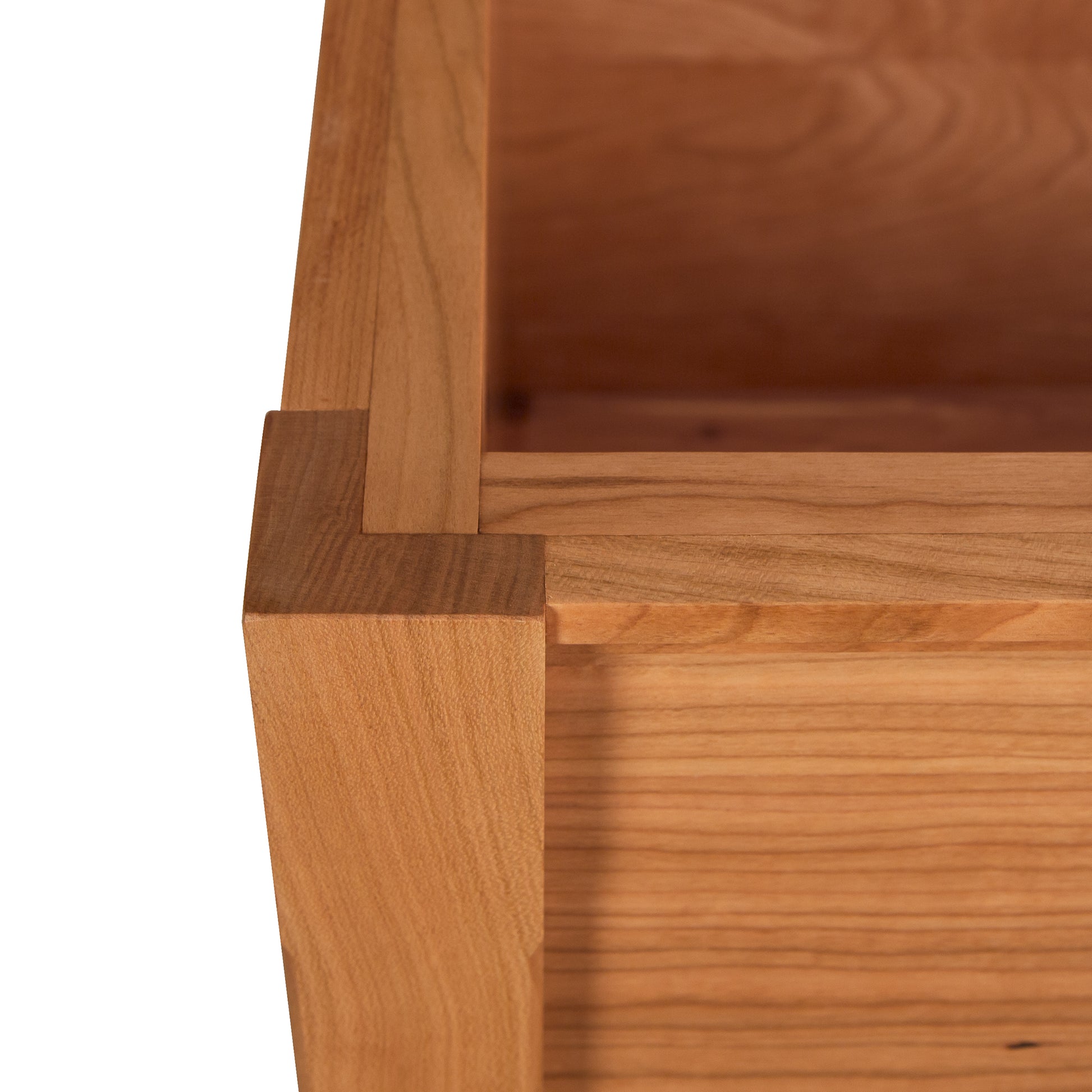 Close-up of corner and wood grain detail in the Vermont Shaker Blanket Chest by Maple Corner Woodworks, showcasing precision craftsmanship from sustainably harvested woods.